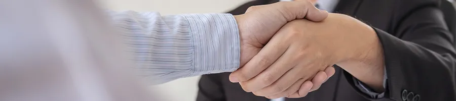 Close up image of shaking hands after discussing who owns an llc