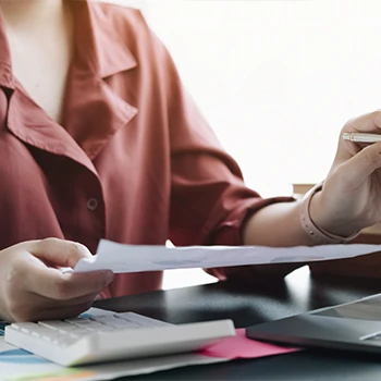 Woman holding a paper writing an agreement