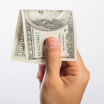 Holding a single dollar bill on a plain background