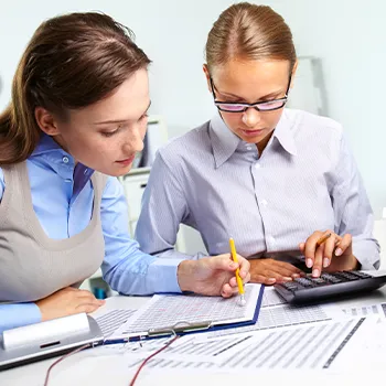 A woman submitting documents with her tax payment