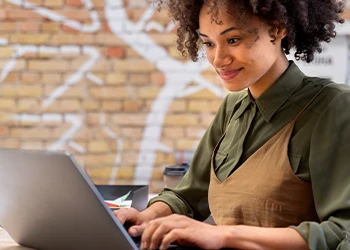 Woman smiling using her laptop