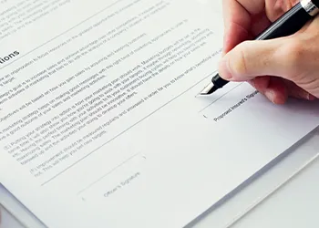 A man signing up on paper about forming an LLC