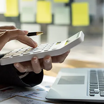 A hand using a calculator in an office