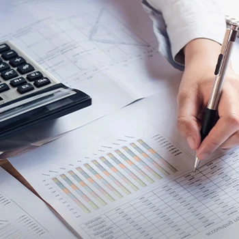 A graph to track taxes and a person calculating the papers