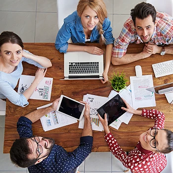 Workers looking at top of camera while working