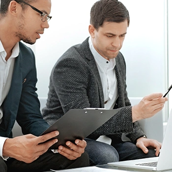 Two men looking at phone to check reference