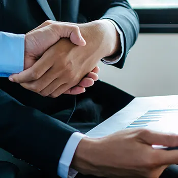 A man shaking hands after learning what are requirements for a New York LLC publishing