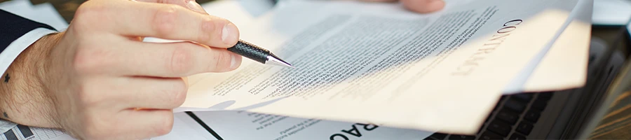 Close up image of a man reading the file thoroughly