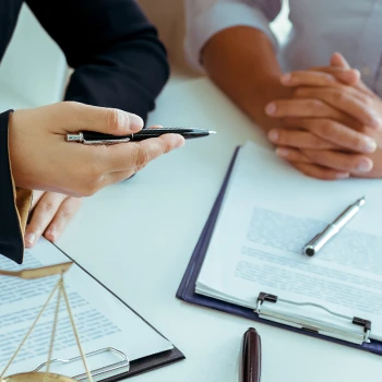 Lawyer having a conversation with client talking about important papers