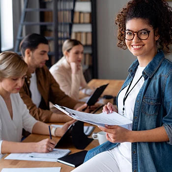 An employee with her team behind her on their LLC physical business address