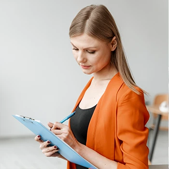 Woman taking note on her clipboard