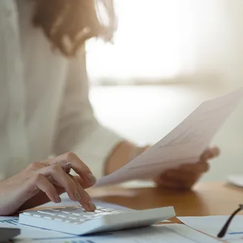 Woman calculating taxes from a file