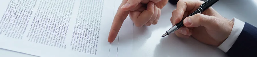 A woman pointing at a document about LLC subsidiary