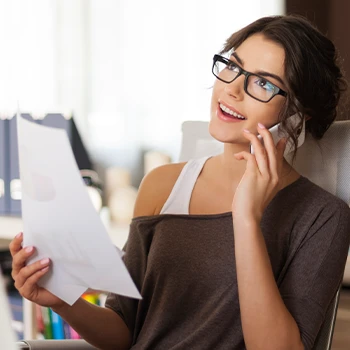 Woman on phone talking to someone about why is an LLC the best business structure