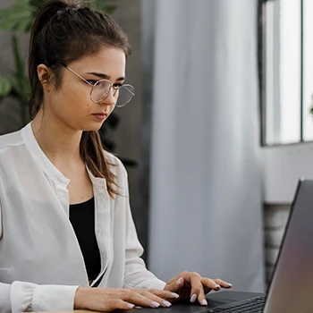 Woman using laptop to explore expedited filing options