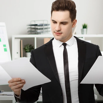 A guy in his office comparing two different files