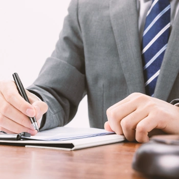 An LLC owner signing an Operating Agreement in an office