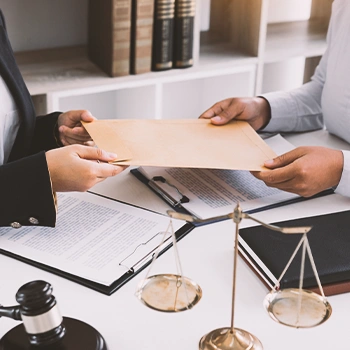 An office working passing a file to another person