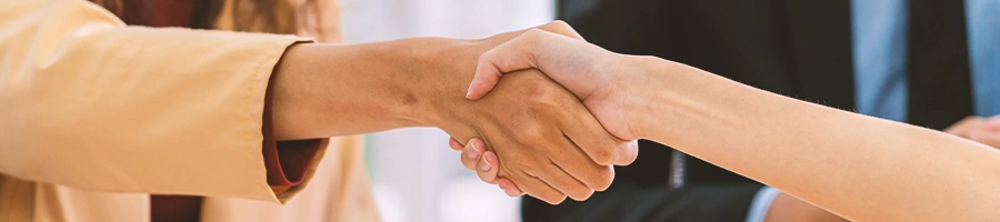 Two office workers shaking hands