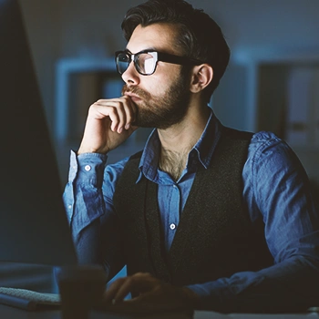 An LLC owner working late at night at the office and searching how long can an llc operate