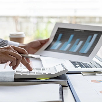 Busy calculating taxes while holding a graph bar report