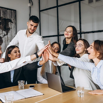 Group of people in an office talking about AMBR