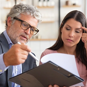 An old man explaining to client about a certain document