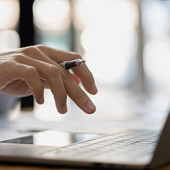 Close up image typing on a laptop keyboard