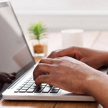 Close up image of a person using a laptop computer device