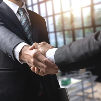 Businessmen shaking hands as a sign of agreement