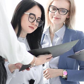 Showing a document to women co workers