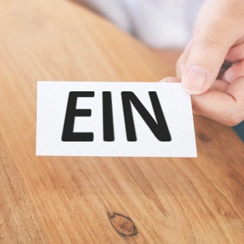 A white card with EIN letters written