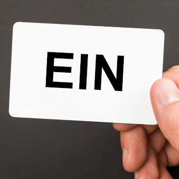 A white card with a n EIN letter marked on it