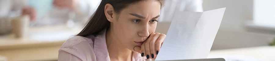 A woman studying the steps on dissolving a Nevada LLC