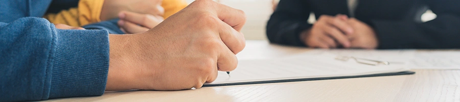 Writing on a table top with different people