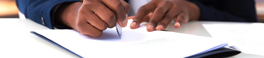 Man in suit writing on paper