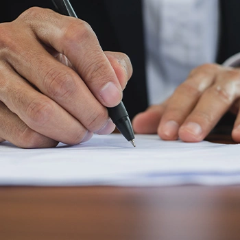 A man signing a document for a Connecticut LLC