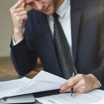 Man seriously working on documents he's working on