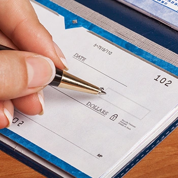 A woman signing an LLC check