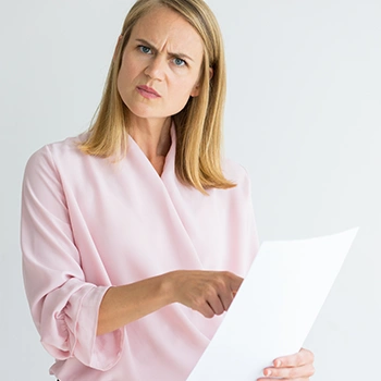 Woman pointing at document seriously