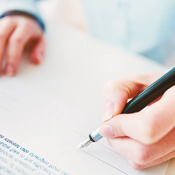 A person signing a paper