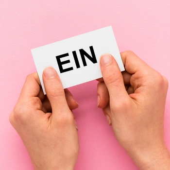 Holding a white card with both hands in pink background