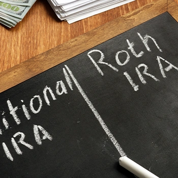 Traditional and Roth IRA written on a chalk board