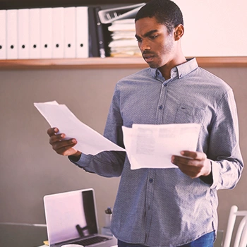 A person looking at two papers