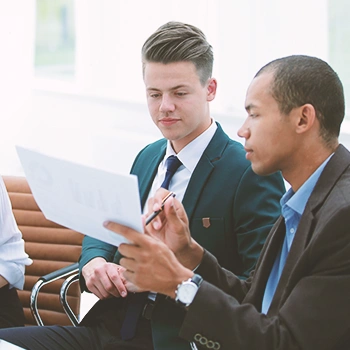 Two office workers discussing paperwork