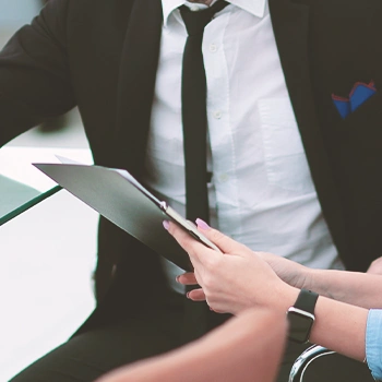 A person holding a clipboard beside a coworker