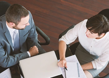 Two coworkers discussing about dissoultion of an LLC in North Dakota