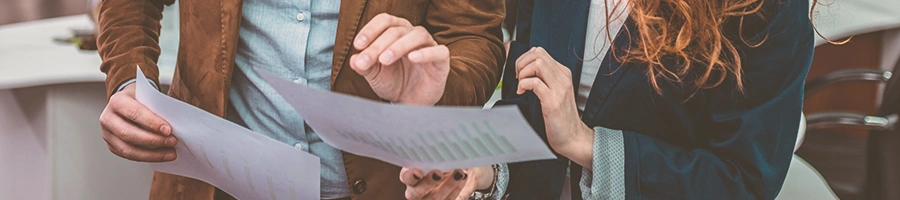 Two office person discussing a paper