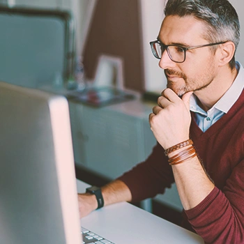 A man thinking while staring at his computer