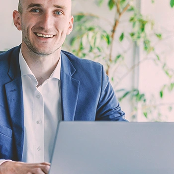 A person on his laptop smiling